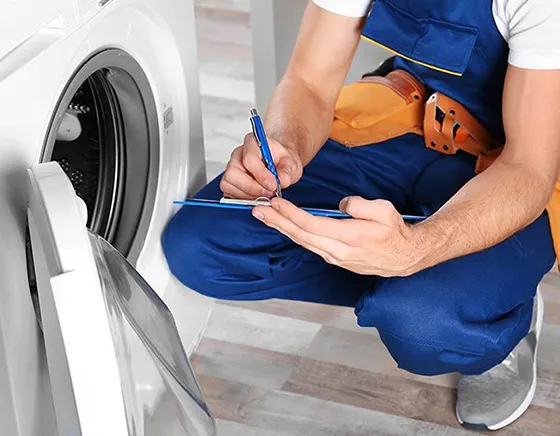 Washer and dryer repair service by a professional technician.